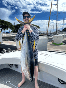 sport fisherman holding yellowfin tuna fishing charter oahu and honolulu